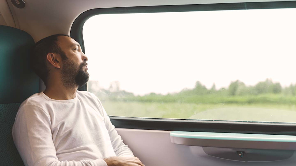 Man thinking on train
