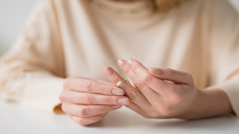 Newsroom - Woman pulling at wedding ring on hand