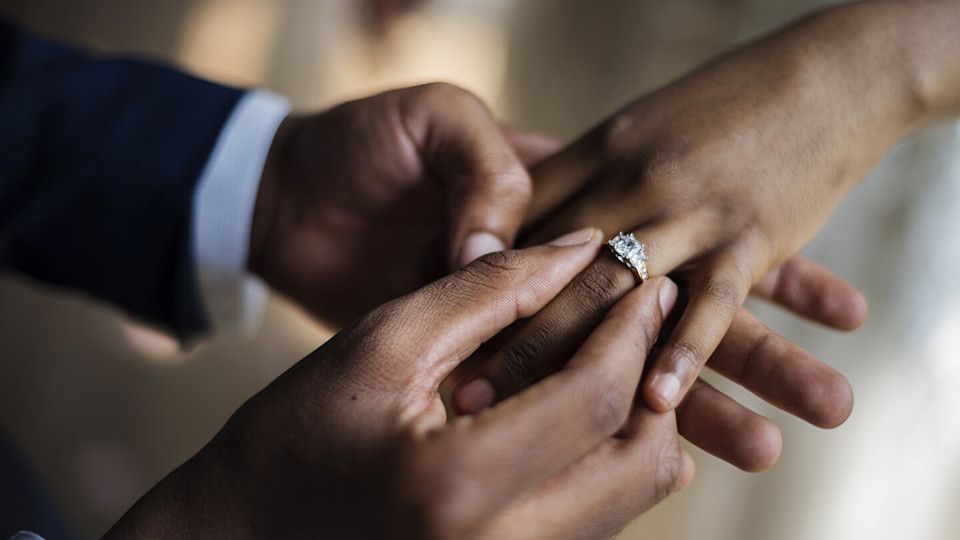 Wedding day putting ring on finger close up