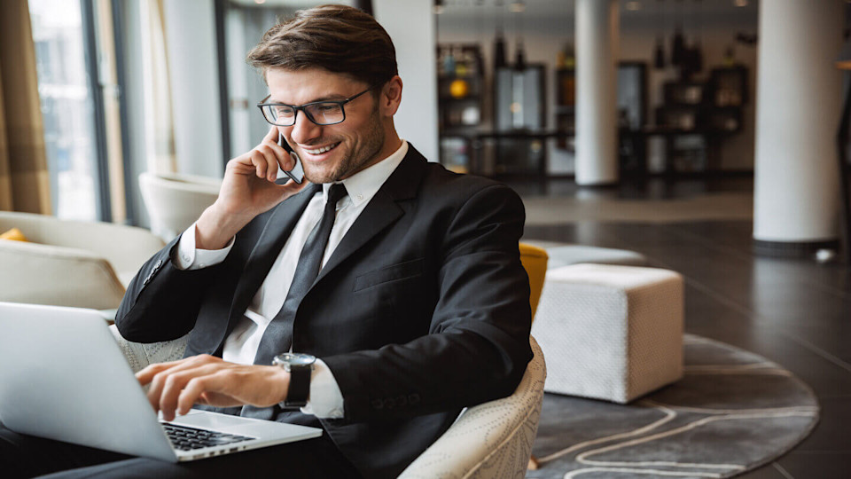 Man on phone with laptop