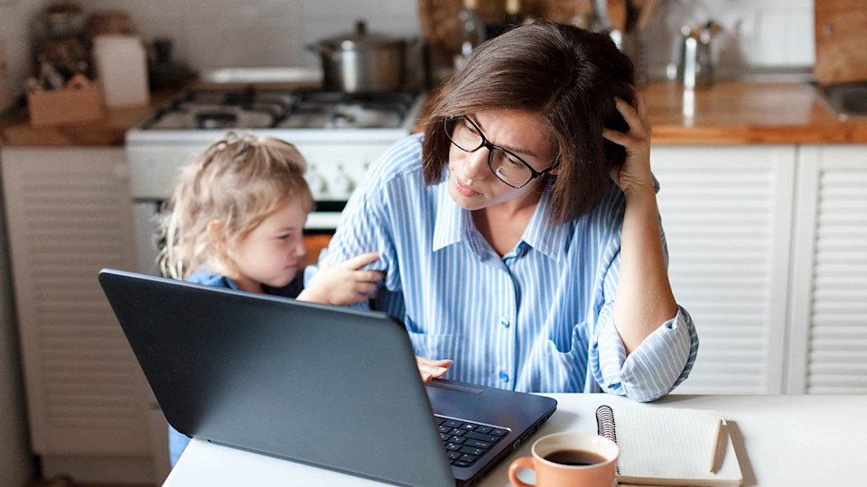 Mum at laptop with child
