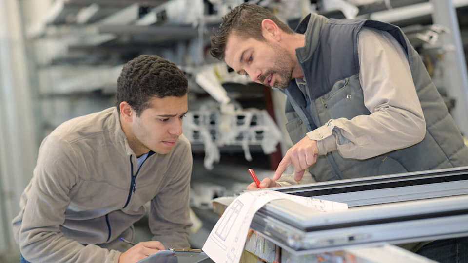 Male supervisor discussing work with worker