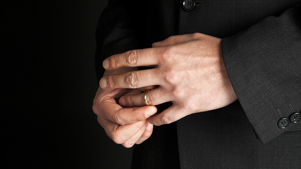 Close up of hands showing wedding band or ring