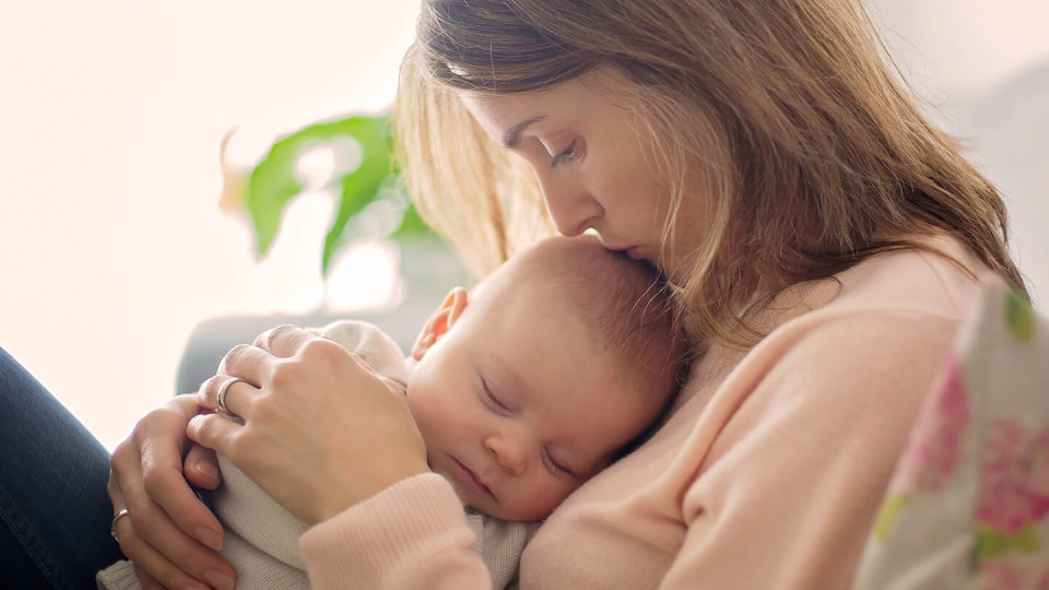 Young mother holding her new born baby