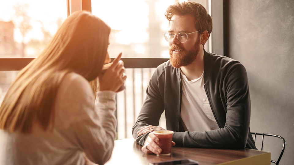 Man in glasses talking to friend