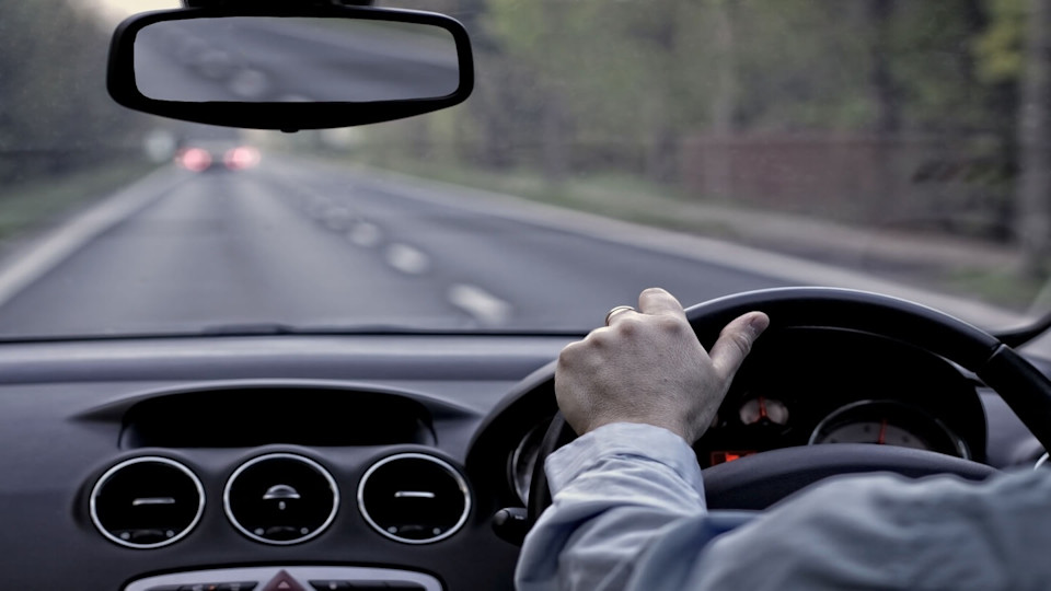 Newsroom - Man driving on a road