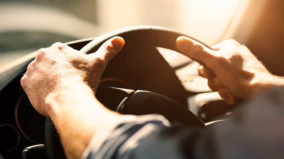 Newsroom imagery - hands on a steering wheel