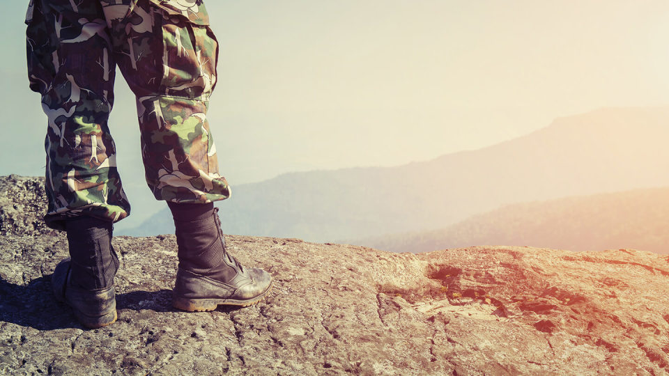 Solider in camo on clifftop