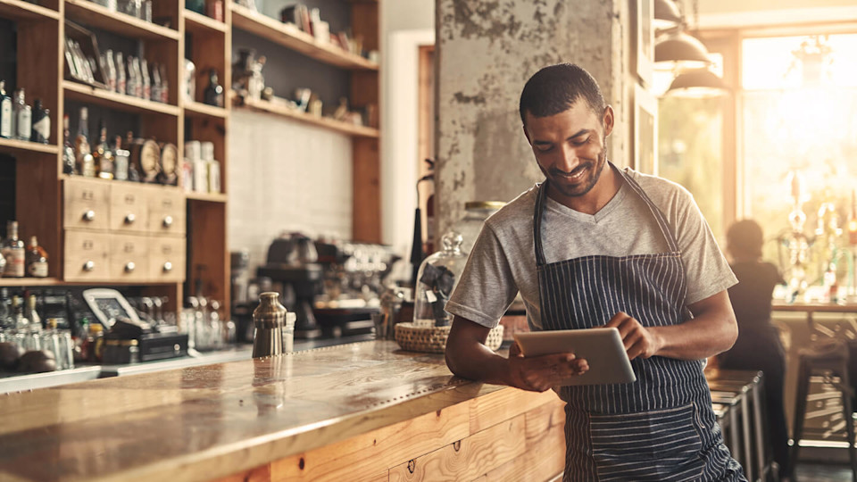 Coffee shop worker using a tablet