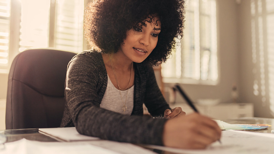 Woman Lawyer working in home office writing.