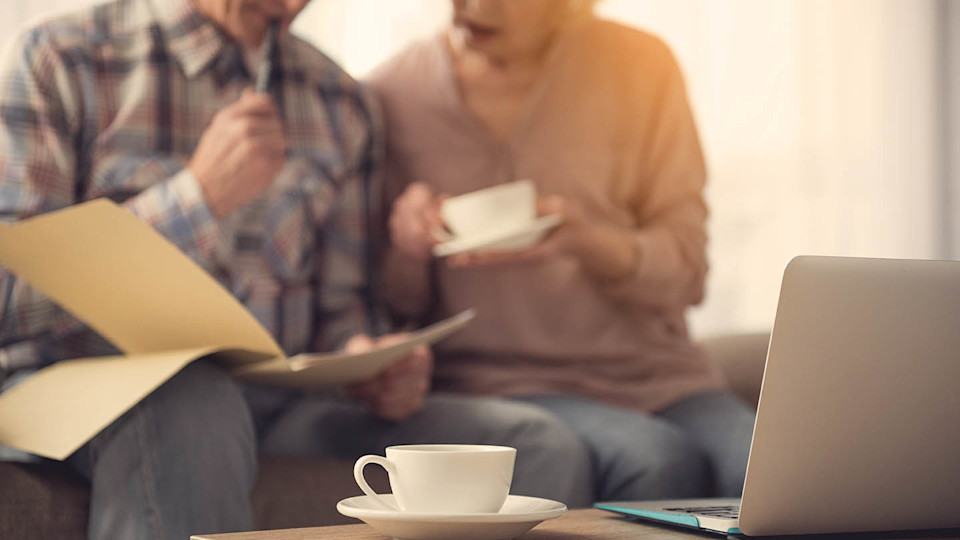 Newsroom Image - couple looking at paperwork while drinking tea