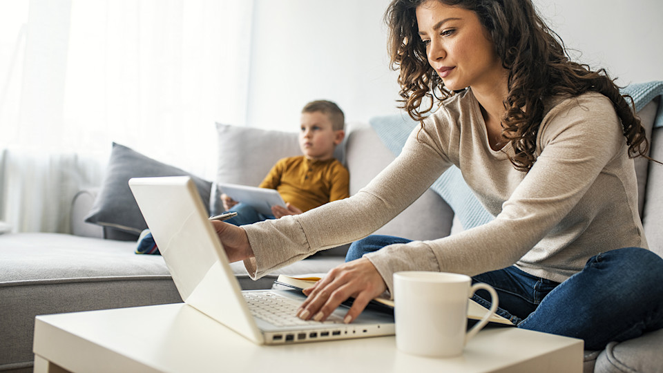 Woman on laptop with child