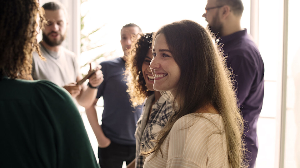 Woman in white top smiling at friend