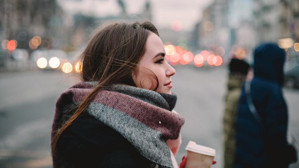 Woman in scarf standing in the city