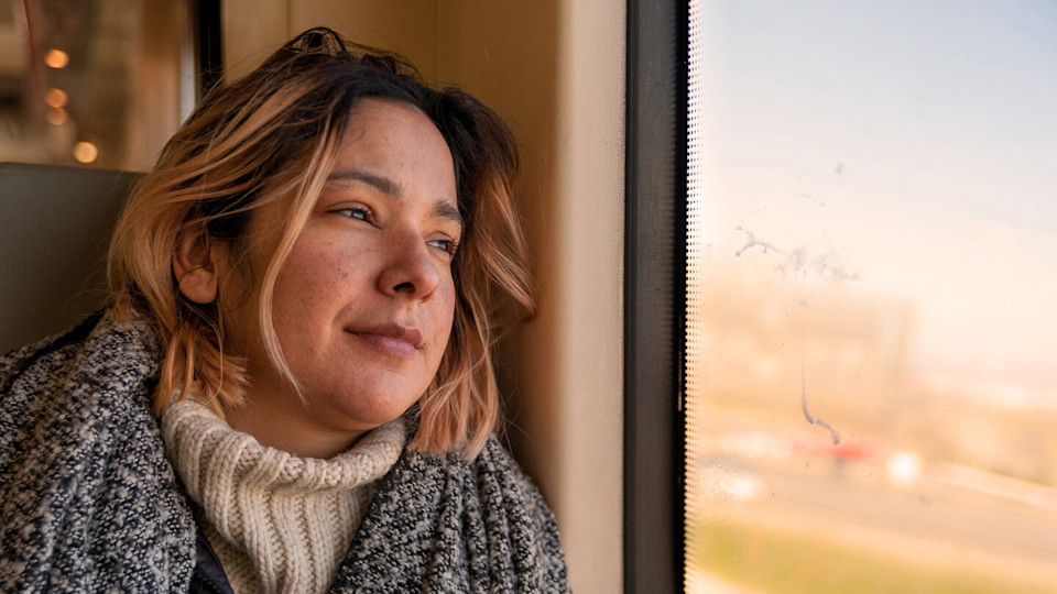 Smiling woman looking out of train window