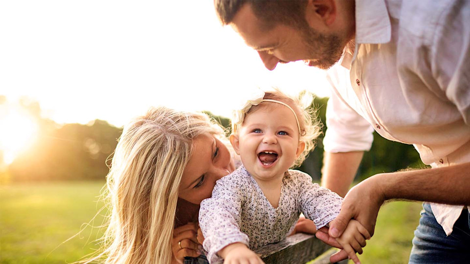 happy family of three outside