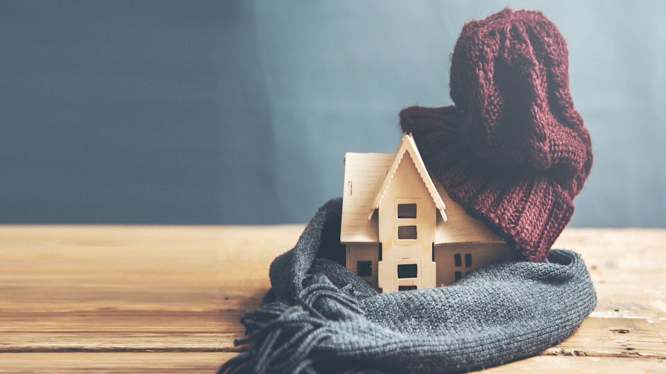 Model house under hat and scarf