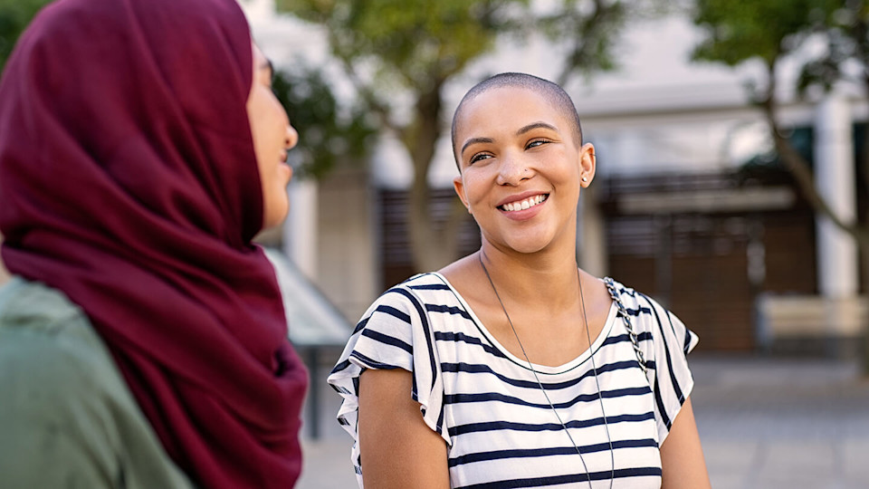 Young woman smiling at friend