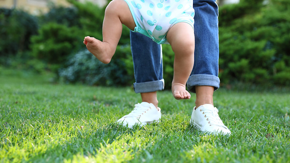 Holding baby to take first steps