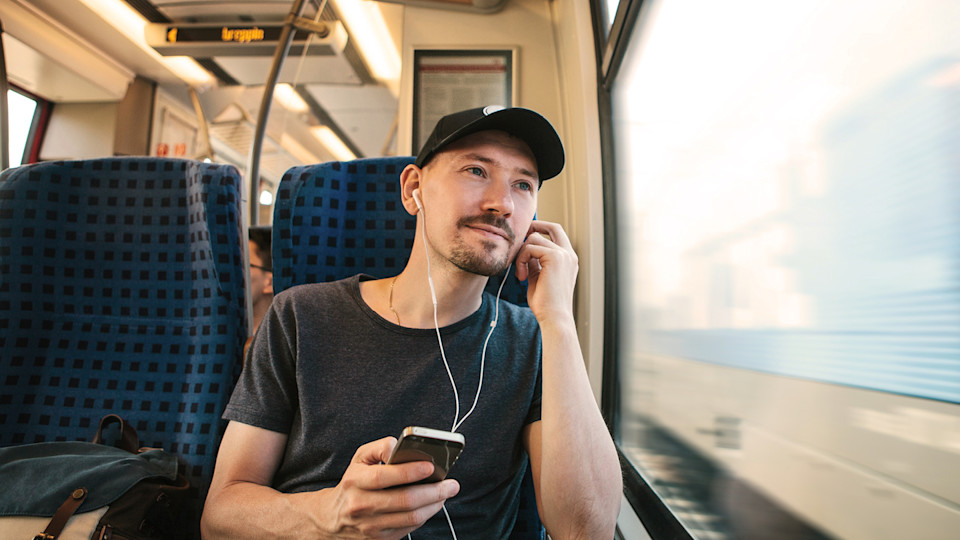 Man with cap on train