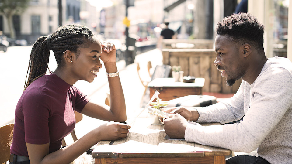 couple sat around table outside