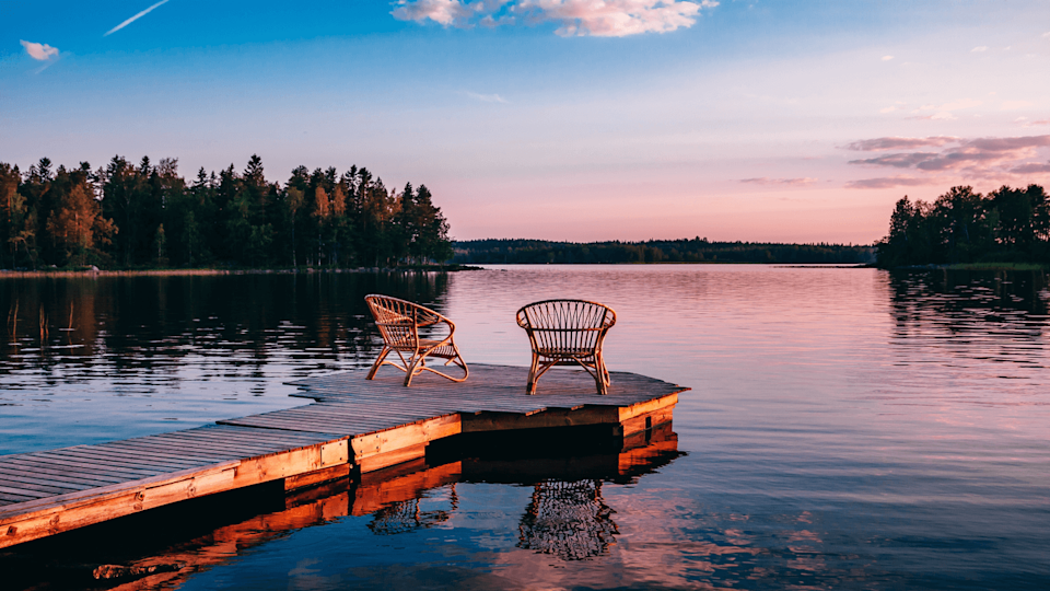 2 chairs on a jetty at sunset