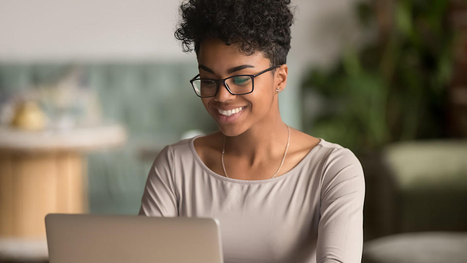 Woman at laptop smiling