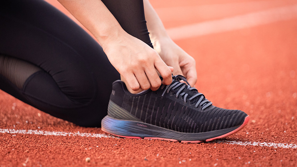 Runner tying shoes