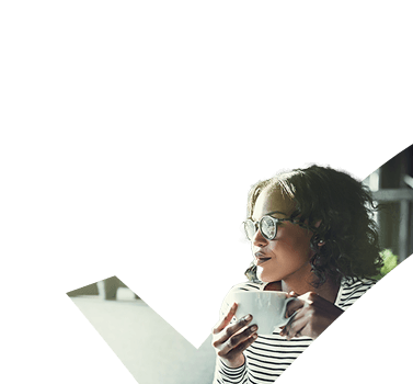 Woman with glasses and mug in hand