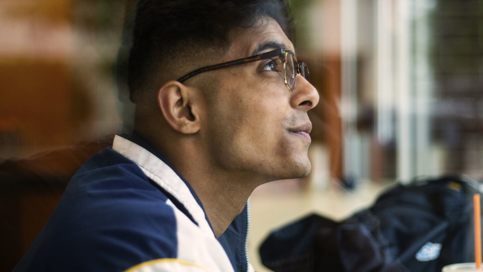 Young man in glasses listening intently