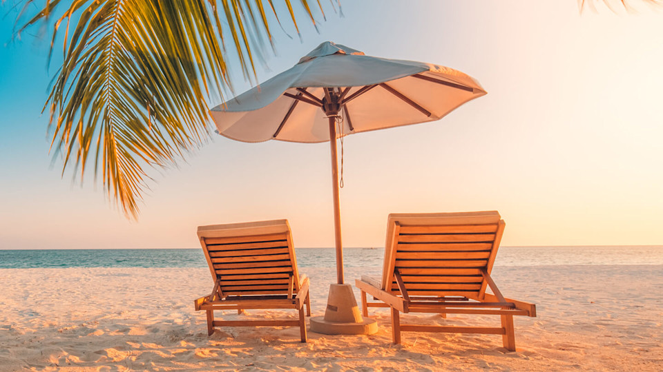 Sunbeds on empty picturesque beach