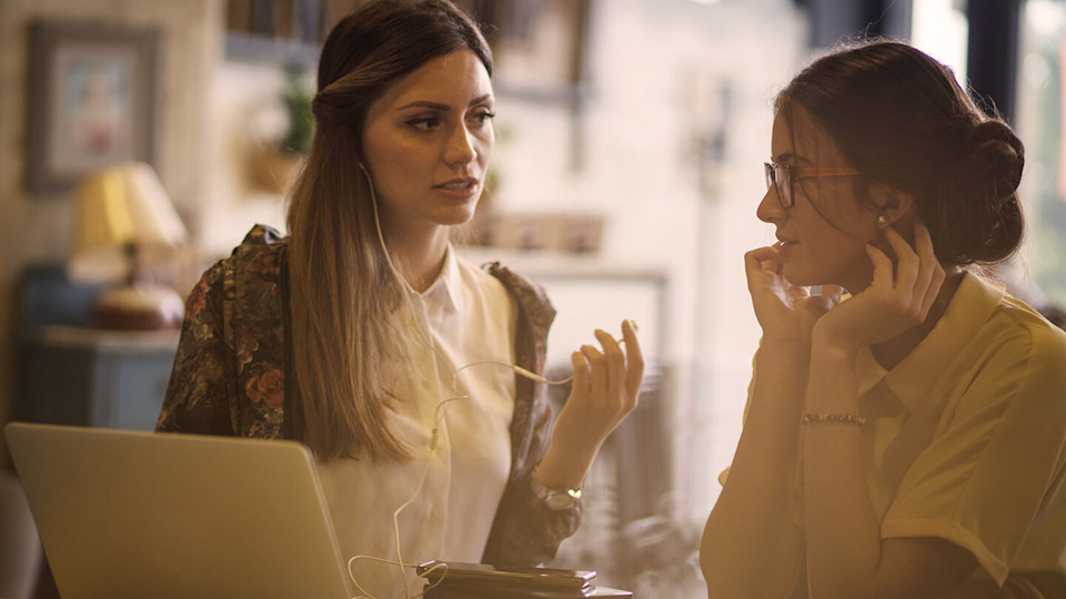 Two friends chatting in a cafe