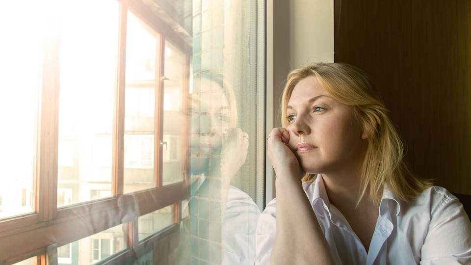 Woman looking out of window