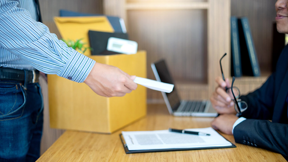 Handing over document to person behind desk