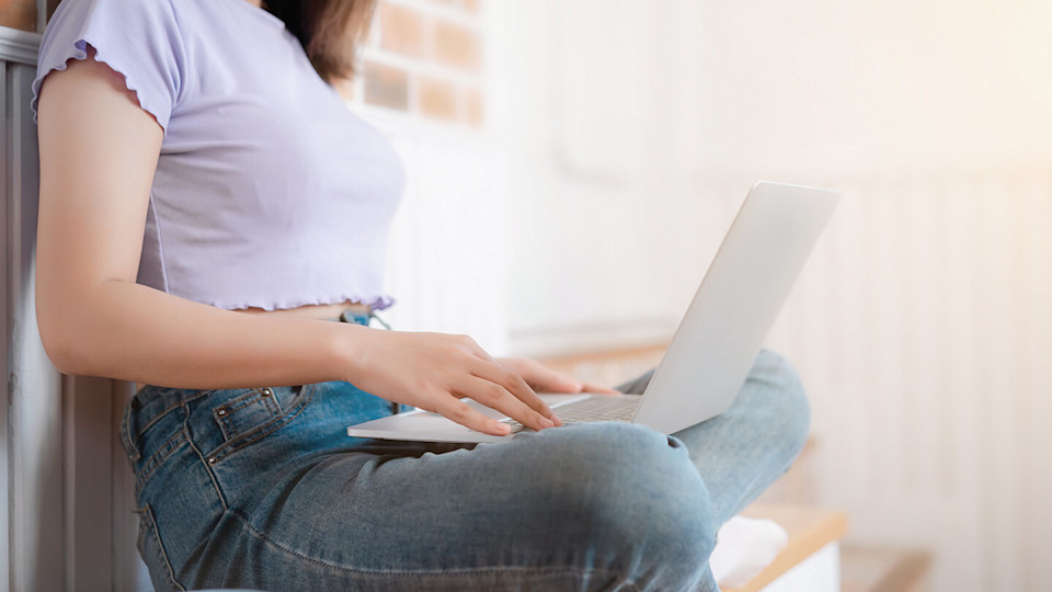 Legs crossed woman on laptop