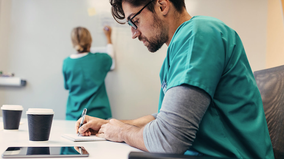 Hospital worker taking notes