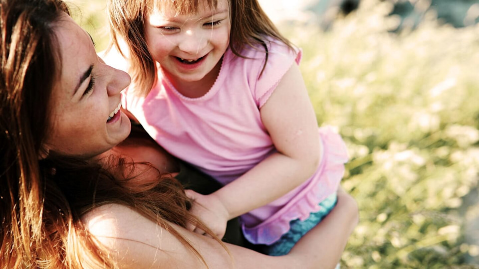 Mother holding her young child