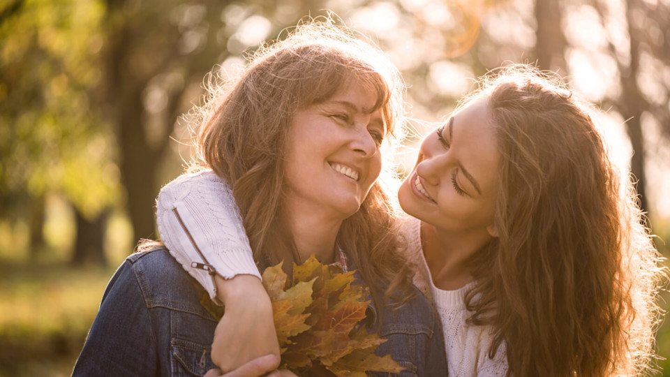 Daughter hugging her mother outside