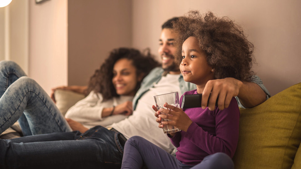 Family happily watching tv