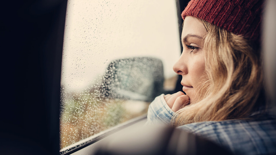 Young woman looking out of car window