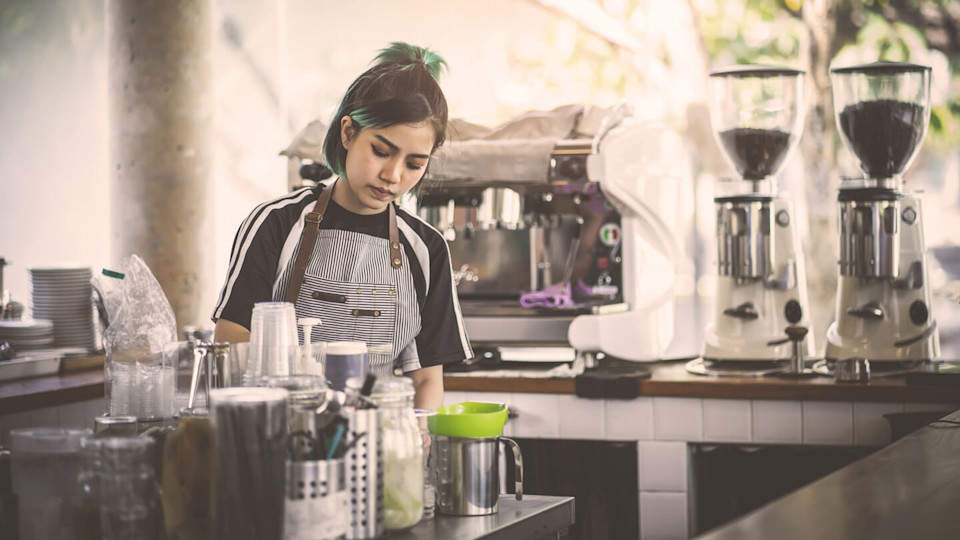 Female barista making coffee in a cafe