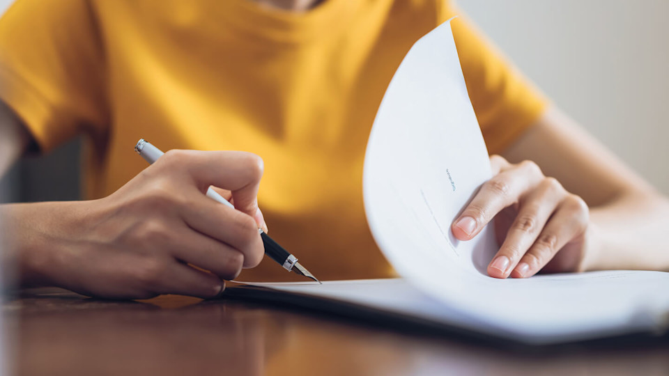 Newsroom - Woman reading contract