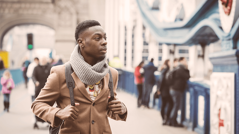 Man walking over bridge